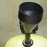 Black dome hole funnel standing on its own in the side fill port on the shoulder of an acid neutralizer tank