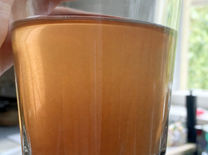 Close-up of well water in a clear glass with subtle blue-green tint from dissolved copper